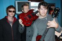 a-ha with the guitar for the Virgin Radio auction - Photo by Virgin Radio